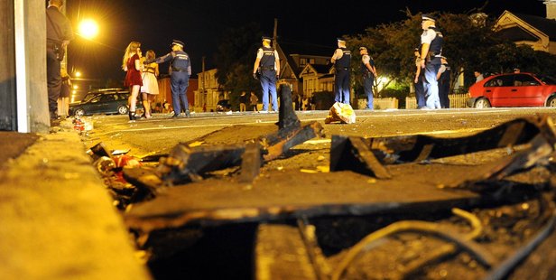 Remains of a furniture fire as Police clear Castle Street of party goers after a large crowd gathered and lit several fires on Saturday night. Photo / Otago Daily Times