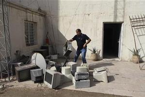 A man cleans up the offices of the Iraqi newspaper, the Constitution, in Baghdad, Iraq. Photo / AP