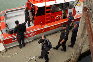 Navy personnel load their sonar equipment before leaving the wharf at Raglan. Photo / Alan Gibson