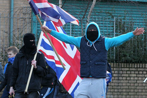 Loyalist protesters stage an angry demonstration with their Union flags in east Belfast. Photo / AFP