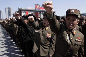 North Korean army officers punch the air as they chant slogans during a rally. Photo / AP