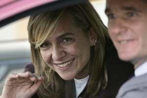 FILE- Spain's Princess Cristina waves from inside a car beside her husband Inaki Urdangarin. Photo / AP