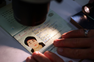 A forged passport undergoes examination at Auckland Airport. Photo / Doug Sherring