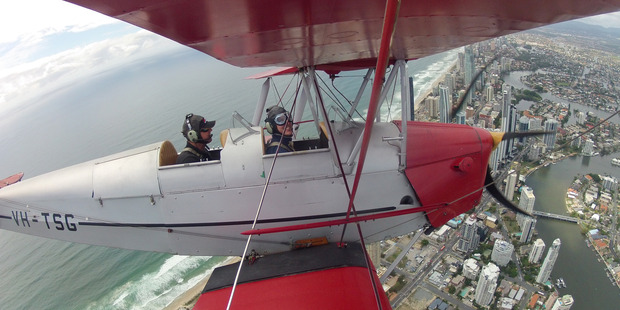 Nicholas Jones gets an elevated view of the Gold Coast with Geoff Stillman, of Tiger Moth Joy Rides. Photo / Supplied