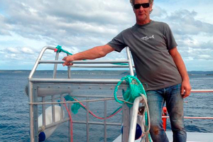 Shark Dive New Zealand director Peter Scott with his new single-man Perspex shark cage. Photo / Otago Daily Times