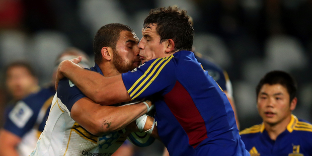 Jordan Smiler of the Brumbies is tackeld by John Hardie of the Highlanders during the round nine Super Rugby match between the Highlanders and the Brumbies. Photo / Getty Images.