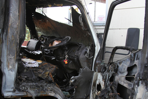 The burned-out cab of the truck that was set alight before it hit Brian and Jane Painter's home. Photo / Supplied