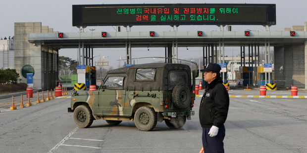 A South Korean military vehicle passes by gates leading to the North Korean city of Kaesong at the customs, immigration and quarantine office near the border village of Panmunjom. Photo / AP