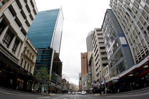 Queen St in Auckland is dwarfed by high-rise towers. Photo / Richard Robinson