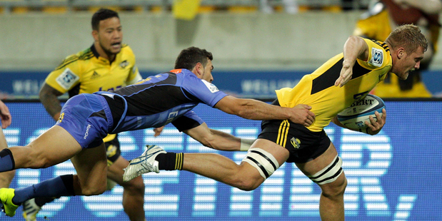 Brad Shields of the Hurricanes on his way to scoring a try in the tackle of Jayden Hayward of the Force. Photo / Getty Images.