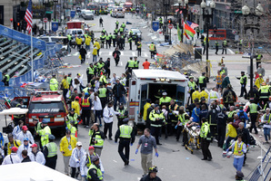 Medical workers aid injured people at the finish line of the 2013 Boston Marathon following the explosions. Photo / AP