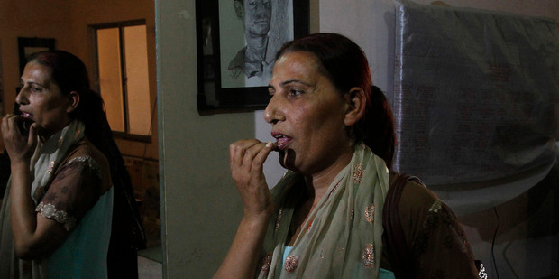 Bindiya Rana, a transgender candidate in Pakistan's elections, applies lipstick before leaves for campaign in Karachi, Pakistan. Photo / AP