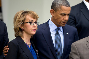 President Barack Obama, right, puts his arm around former Rep. Gabrielle Giffords, D-Ariz., before he speaks in the Rose Garden at the White House in Washington. Photo / AP