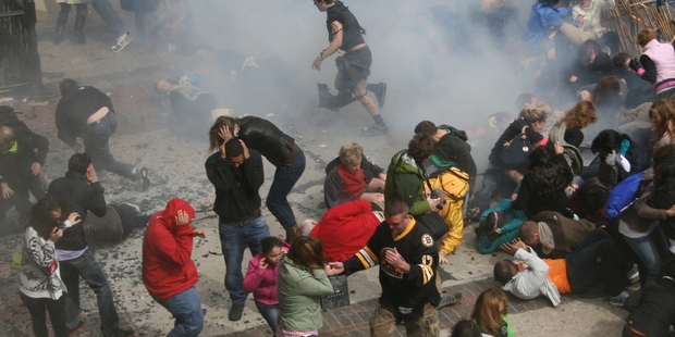 Investigators have been poring over millions of photographic and video images such as this photo taken as one of two explosions ripped into crowds at this week's Boston Marathon. Photo / AP