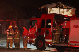 Rescue workers gather near a damaged apartment complex after a nearby fertilizer plant exploded in West, Texas. Photo / AP