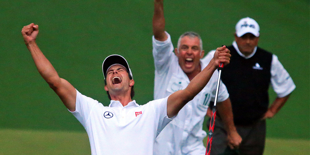 Adam Scott celebrates winning the US Masters, with caddie Steve Williams in the background and playoff runner-up Angel Cabrera behind him. Photo / AP