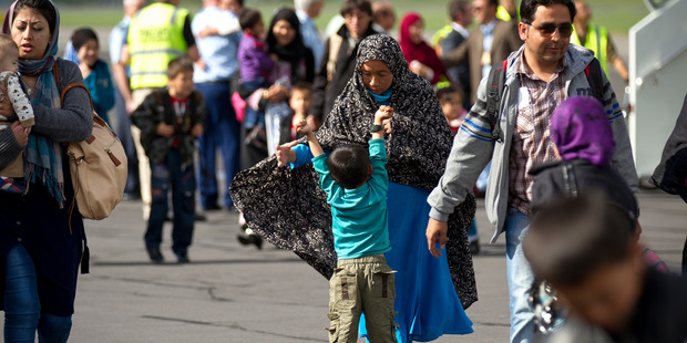 Afghan interpreters and their families arriving yesterday at Whenuapai airbase to begin new lives in New Zealand. Photo / Dean Purcell