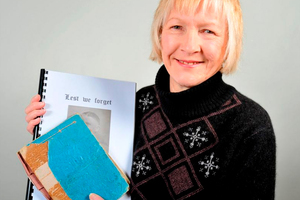 Margaret Pollock with the original version and a digital version of her late father's diary of life in European prisoner of war camps during World War 2. Photo / Otago Daily Times