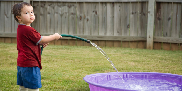 Leaving a home that is nearly mortgage-free, with space for the children to play in, to move to a more desirable suburb can be a tricky decision. Photo / Getty Images