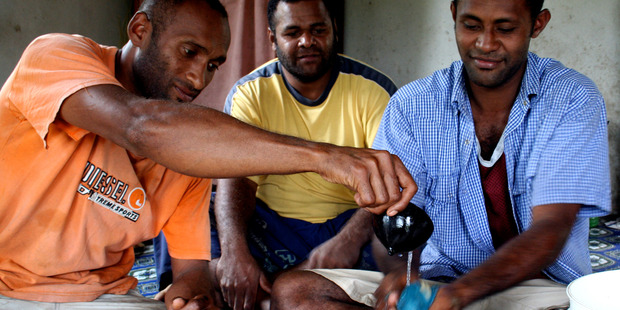 Tony (far right) accepts a bowl of traditional Fijian kava. Photo / Derek Cheng