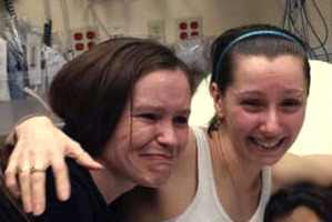 Amanda Berry, right, hugs her sister Beth Serrano after being reunited in a Cleveland hospital. Photo / AP