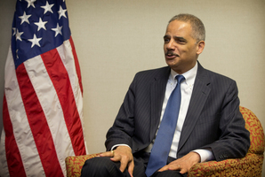 US Attorney General Eric Holder talks with media during his brief visit to New Zealand. Photo / Greg Bowker