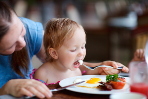 Eating at the table alongside parents can discourage food fads. Photo / Getty Images