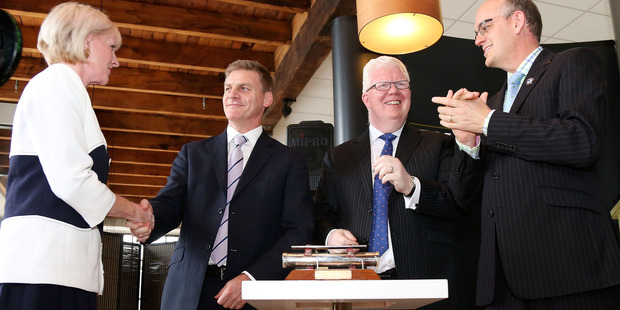 Mighty River Power chairwoman Joan Withers, Bill English, NZX CEO Tim Bennett and Tony Ryall congratulate one another during the listing of MRP at NZX. Photo / Getty Images