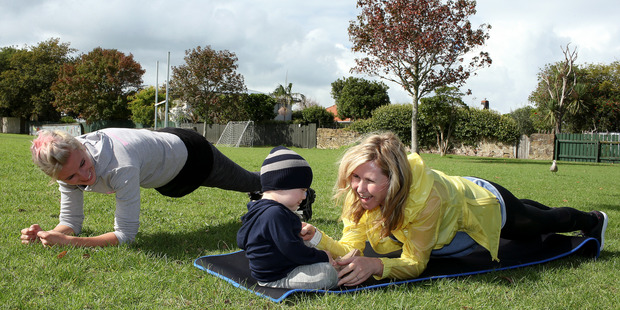 Trainer Simone Rank takes Rachel Grunwell and her baby, Finn Grunwell, (22 months) through exercises during a boot camp session at Rose Park, Belmont. Photo / Getty Images