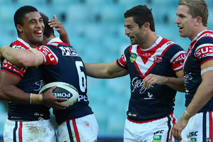 Michael Jennings of the Roosters celebrates scoring a try with teammates. Photo / Getty Images