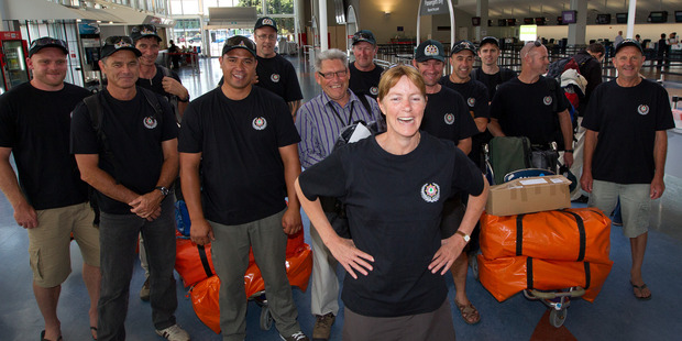 Whangarei Rural Fire and Department of Conservation (DOC) employee Clea Gardiner (C) pictured at Auckland International Airport with her fellow team members this morning. Photo / Sarah Ivey