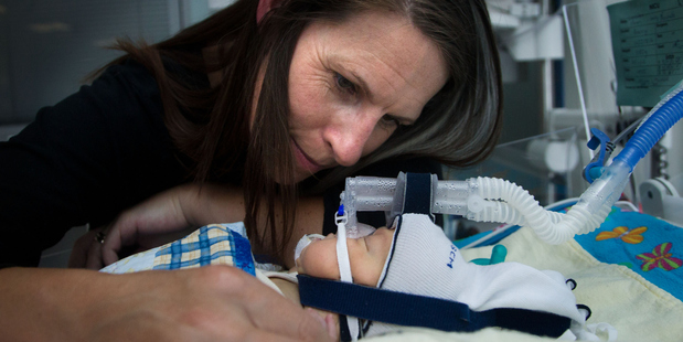 Michelle Bain with her 9-week-old, Lachlan, in Wellington Hospital's neonatal intensive care unit yesterday. He has been in the unit since being born 16 weeks premature. Photo / Marty Melville
