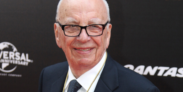 Media magnate Rupert Murdoch, pictured with his wife Wendi, is restructuring his businesses after the hacking scandal. Photo / AP