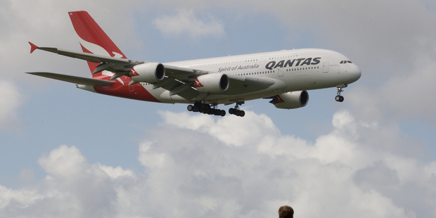 Qantas' Airbus A380, watched by spectators at the Puhinui lookout, comes in to land at Auckland Airport after a scenic flight around the upper North Island. Photo / Paul Estcourt