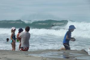 A surfer catches a big wave at Waipu. Photo / Rachael Snook
