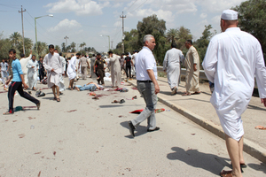 Iraqis gather at the scene of a bomb attack in Baqouba, northeast of Baghdad, Iraq.Photo / AP
