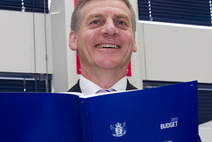 Finance Minister Bill English viewing a copy of the 2013 Budget. Photo / Mark Mitchell