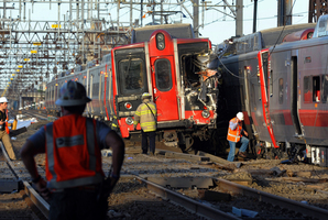 Emergency personnel work at the scene where two Metro North commuter trains collided. Photo / AP