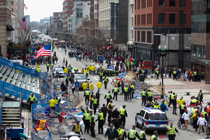 First responders rush to where two explosions occurred along the final stretch of the Boston Marathon on Boylston Street in Boston. Photo / AP
