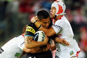 Dean Whare of the Panthers is tackled by Jason Nightingale and Jamie Soward of the Dragons in their NRL clash last night. Photo / Getty Images