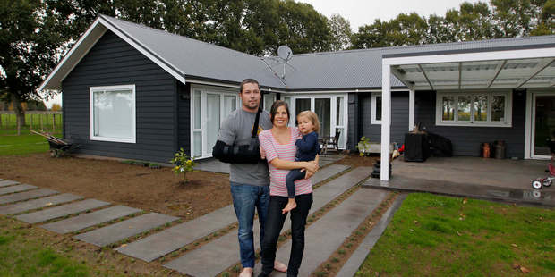 Carlos and Annabel Barbosa with 2-year-old Greta at their Mystery Creek home. Photo / Christine Cornege