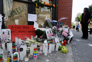 Pedestrians pass a makeshift memorial for 32-year-old Mark Carson. Photo / AP