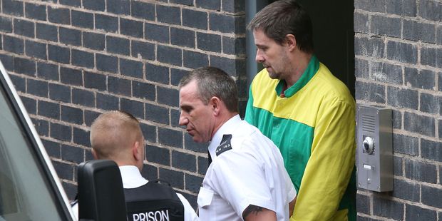 Mark Bridger, right, leaves the Crown Court in Mold Wales after he was given a life sentence for the abduction and murder of schoolgirl April Jones. Photo / AP