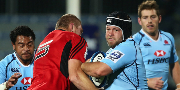 Benn Robinson of the Waratahs runs with the ball into defender Dominic Bird of the Crusaders. Photo / Getty Images.