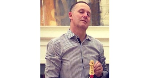 John Key's snap with a bottle of Moet champagne has been doing the rounds on social media. Photo / Supplied