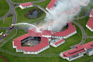 Smoke billows from two beseiged cell blocks at the Spring Hill Prison in the north Waikato. Photo / Doug Sherring