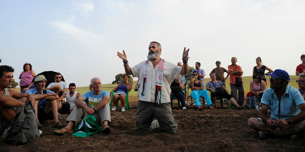 Marinaleda Mayor Juan Manuel Sanchez Gordillo with fellow activists who now work on seized land. Photo / AFP