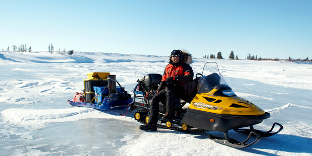 Photographer Chris McLennan aboard a snowmobile in Alaska. Photo / Chris McLennan
