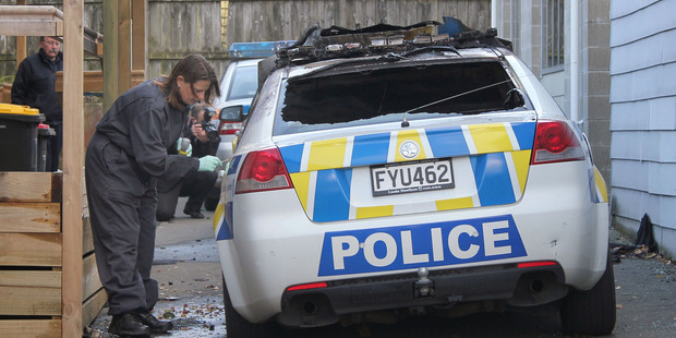 A burnt out police car outside the Lyttelton Police Station. Photo / Christine De Felice