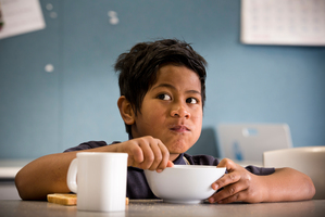 Filo Kaio, 7, enjoys his breakfast before starting his morning at Randwick Park School in Manurewa. Photo / Greg Bowker